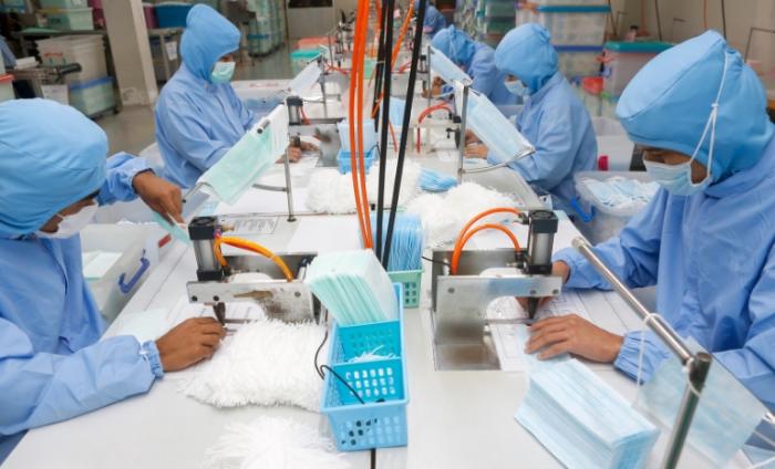 Image showing workers in PPE in a factory making face coverings