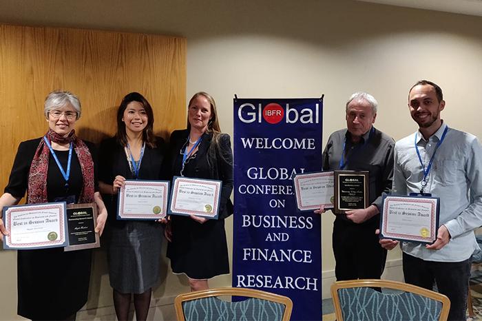 Photo of the staff who won a Finance Award holding their certificates. From left to right: Magda David Hercheui, Lynsie Chew, Danusia M. Wysocki, Alan Parkinson, and Elliot Guner